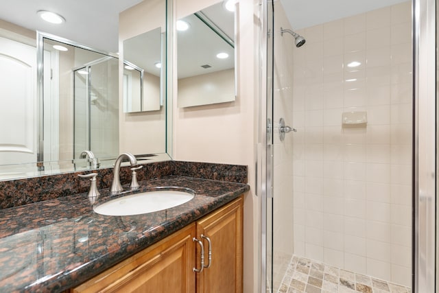 bathroom featuring vanity and an enclosed shower