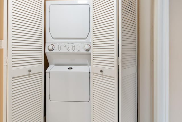 laundry room with stacked washer / dryer