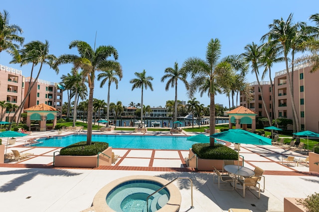 view of swimming pool featuring a community hot tub, a gazebo, and a patio area