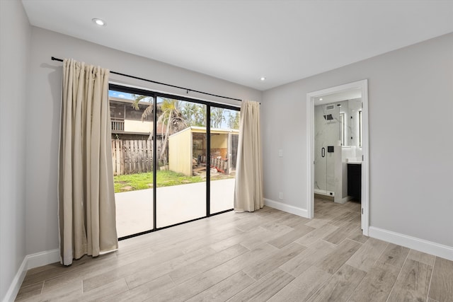 spare room with light hardwood / wood-style flooring