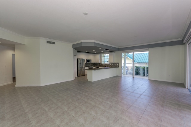 unfurnished living room with ornamental molding and light tile patterned floors