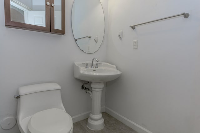 bathroom with tile patterned floors and toilet