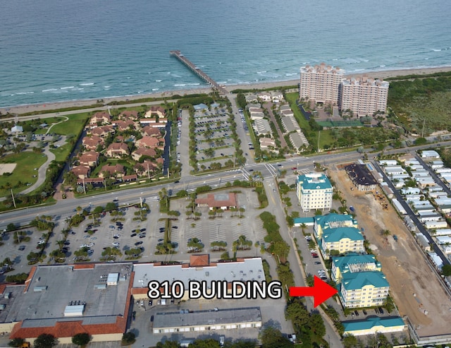 aerial view with a water view and a view of the beach