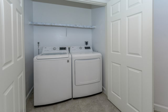 washroom featuring washing machine and clothes dryer and light tile patterned floors