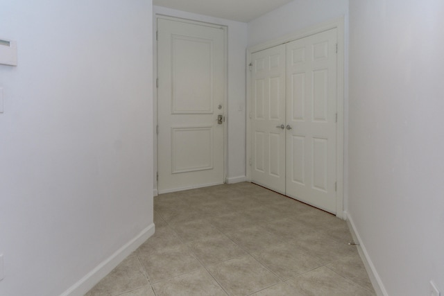 corridor with light tile patterned floors