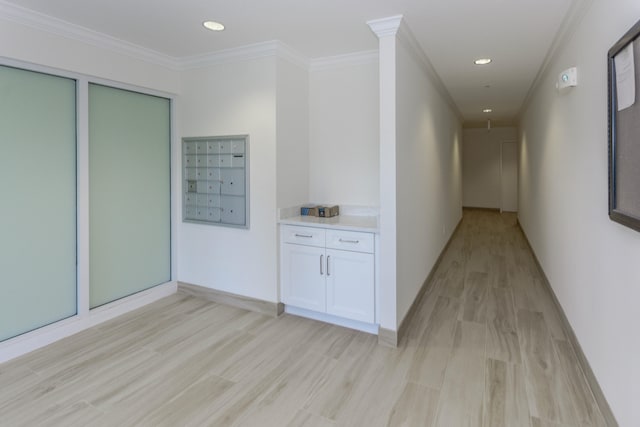 hall with ornamental molding, mail boxes, and light hardwood / wood-style floors