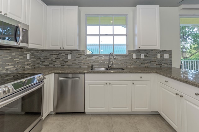 kitchen with white cabinets, dark stone counters, sink, and appliances with stainless steel finishes