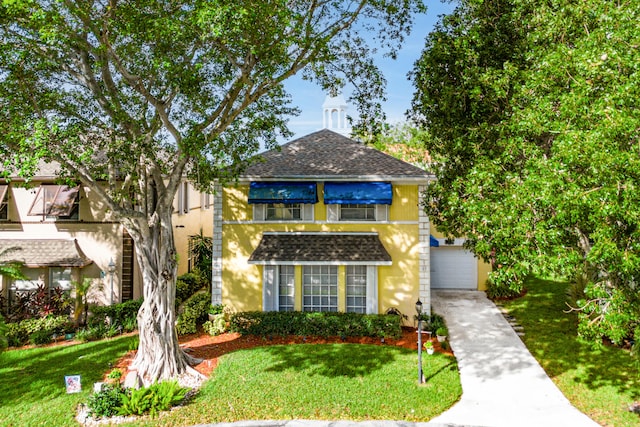 view of front of home featuring a garage and a front lawn