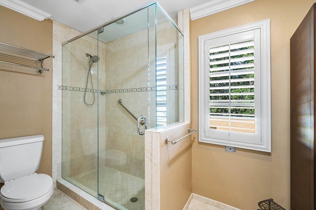 bathroom with tile patterned flooring, ornamental molding, an enclosed shower, and toilet