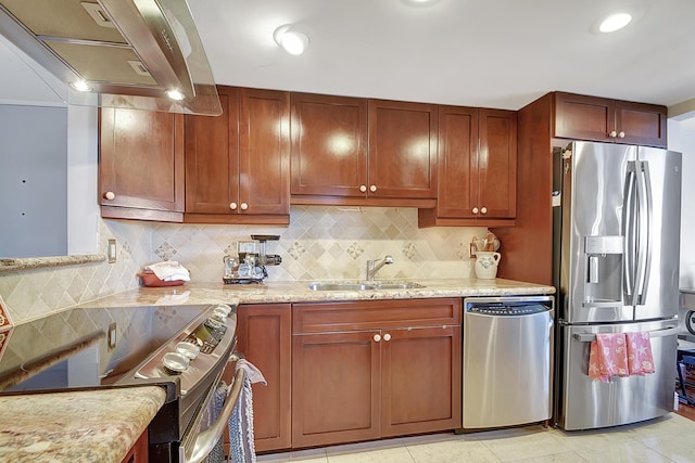 kitchen with backsplash, stainless steel appliances, light stone countertops, and sink