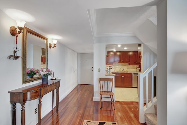 interior space with decorative backsplash, light hardwood / wood-style flooring, and dishwasher