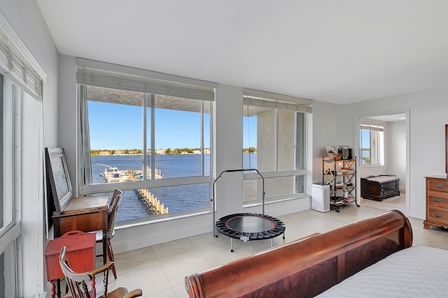 sunroom / solarium with a water view