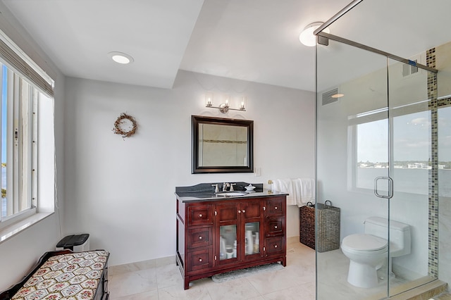 bathroom with a shower with door, a water view, toilet, vanity, and tile patterned flooring