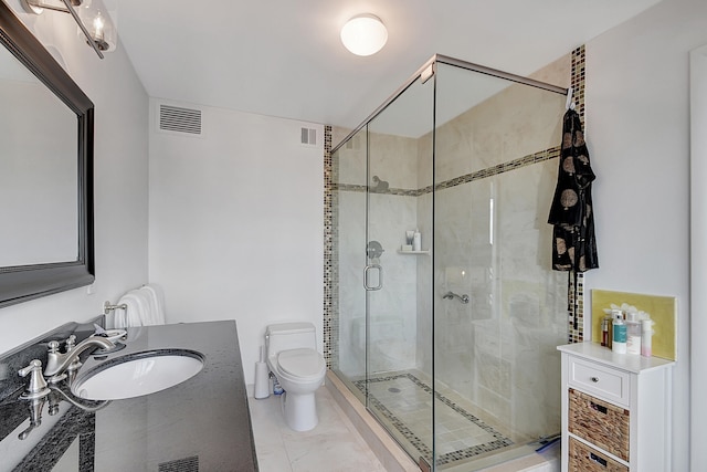 bathroom with vanity, toilet, and a shower with shower door