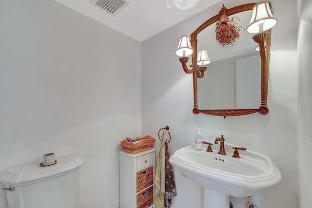 bathroom featuring toilet and sink