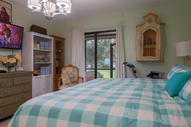 bedroom with access to outside and a chandelier