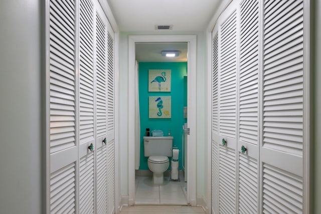 hallway with light tile patterned floors