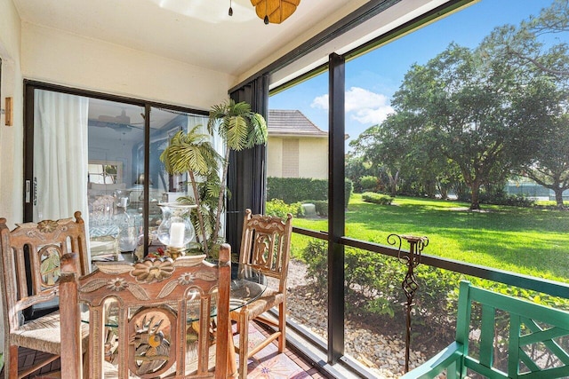 sunroom featuring ceiling fan