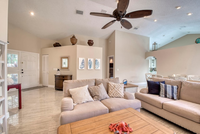 living room featuring a textured ceiling, high vaulted ceiling, and ceiling fan