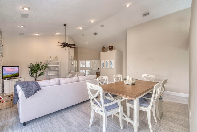 dining space with light hardwood / wood-style flooring, lofted ceiling, and ceiling fan