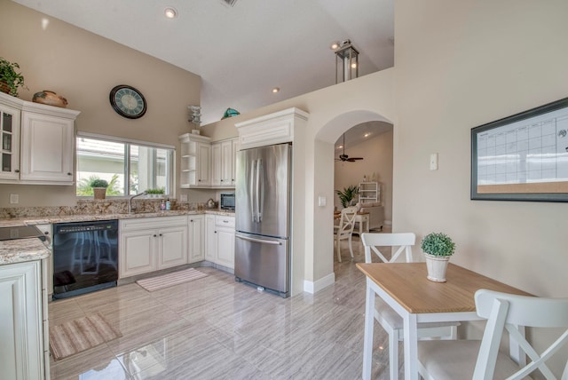 kitchen with black dishwasher, white cabinets, high vaulted ceiling, and stainless steel refrigerator