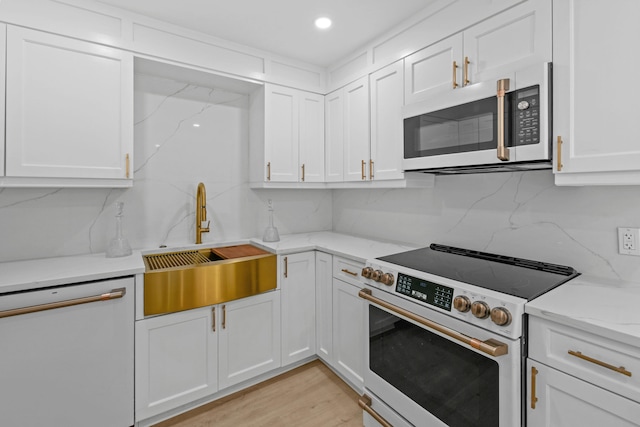 kitchen with stainless steel appliances and white cabinetry