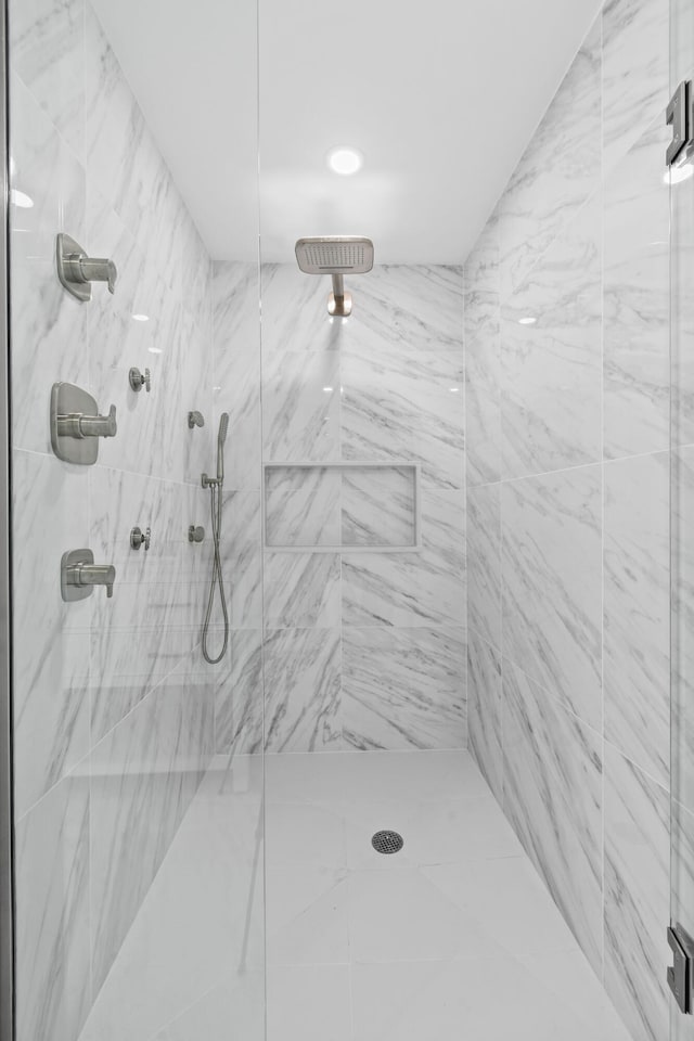 bathroom with a tile shower