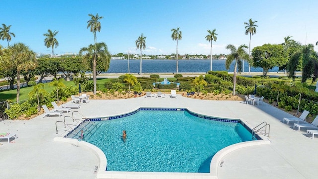 view of swimming pool featuring a patio area and a water view