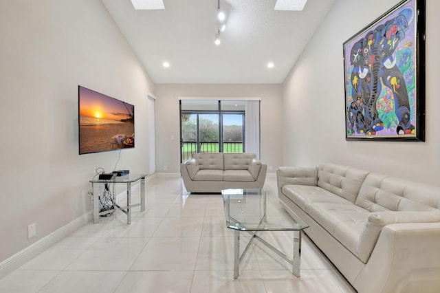 tiled living room with vaulted ceiling with skylight