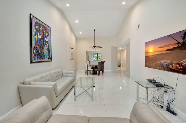 living room featuring light tile patterned flooring, high vaulted ceiling, and ceiling fan