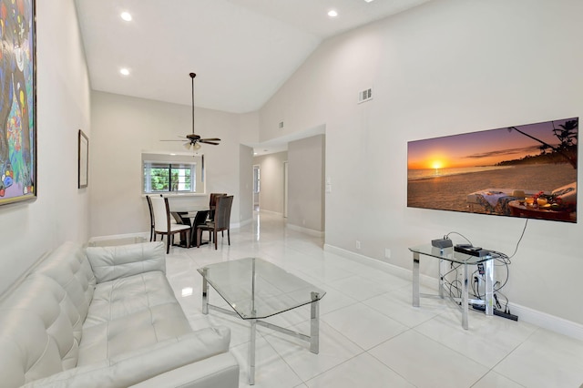 tiled living room with high vaulted ceiling and ceiling fan