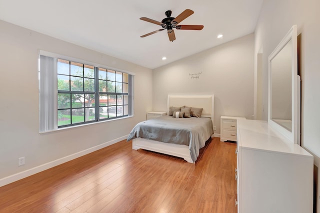 bedroom featuring ceiling fan, lofted ceiling, and light wood-type flooring