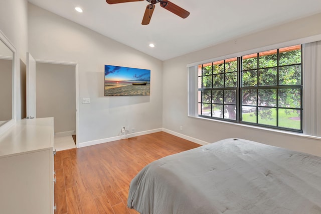 bedroom with vaulted ceiling, light wood-type flooring, and ceiling fan