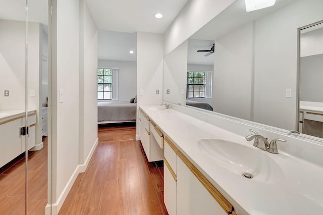 bathroom with vanity, ceiling fan, and hardwood / wood-style floors