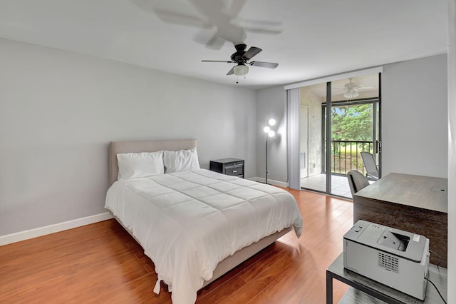 bedroom featuring access to outside, hardwood / wood-style floors, and ceiling fan