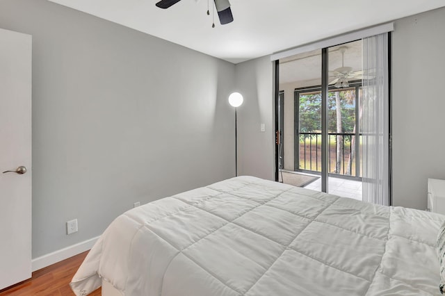 bedroom featuring wood-type flooring, access to outside, and ceiling fan