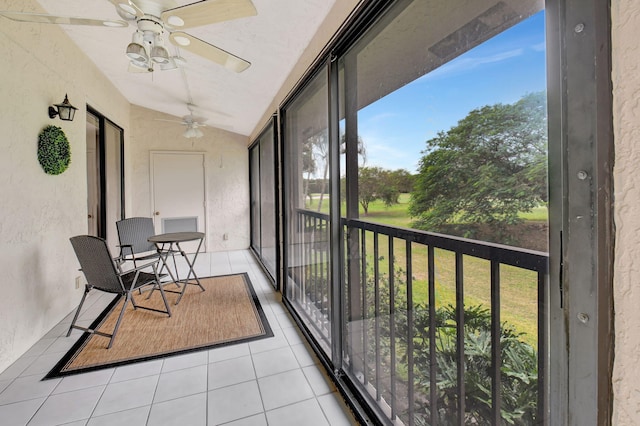 sunroom featuring ceiling fan and vaulted ceiling