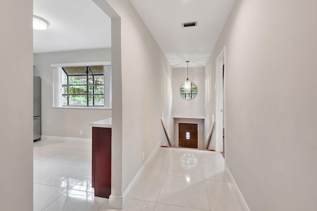 hall with light tile patterned flooring