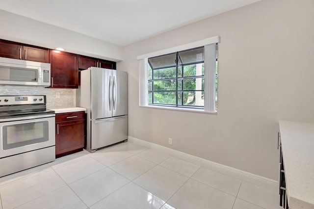 kitchen featuring tasteful backsplash, appliances with stainless steel finishes, and light tile patterned floors