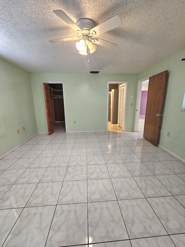 275 SE 16th Ave, Okeechobee, FL 34974 - unfurnished bedroom with a textured ceiling, ceiling fan, and a closet