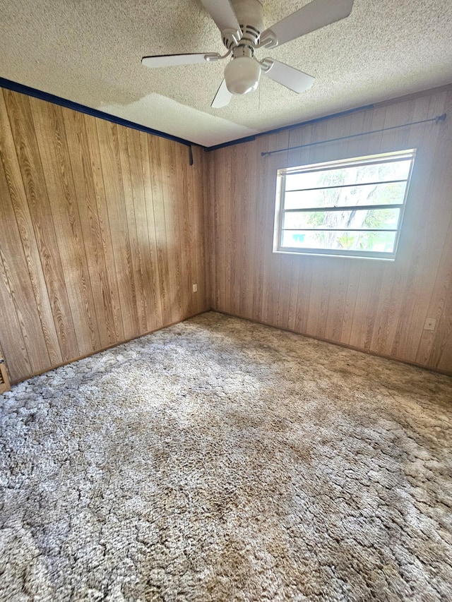 275 SE 16th Ave, Okeechobee, FL 34974 - unfurnished room with carpet, wooden walls, ceiling fan, and a textured ceiling