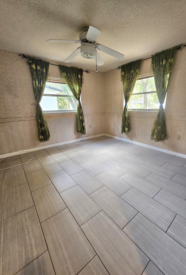 275 SE 16th Ave, Okeechobee, FL 34974 - unfurnished room featuring ceiling fan, a textured ceiling, and baseboards