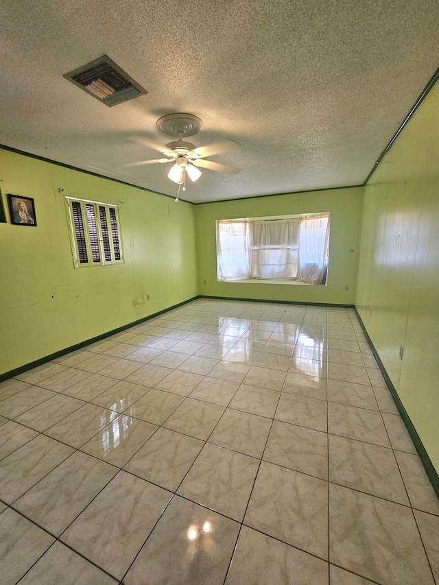275 SE 16th Ave, Okeechobee, FL 34974 - unfurnished room with a textured ceiling, ceiling fan, light tile patterned floors, and baseboards