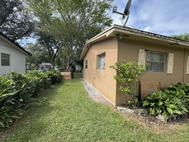 275 SE 16th Ave, Okeechobee, FL 34974 - view of property exterior with stucco siding and a lawn