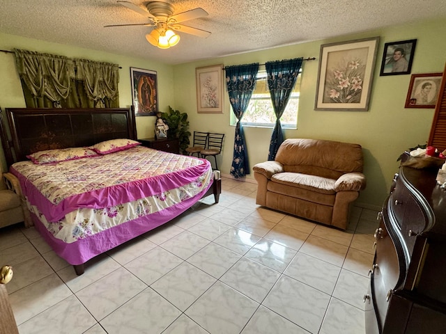 bedroom featuring ceiling fan, a textured ceiling, and light tile patterned floors