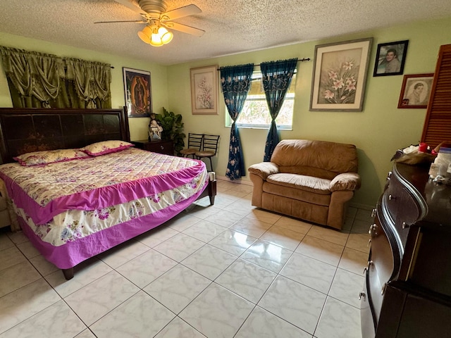 tiled bedroom with ceiling fan and a textured ceiling