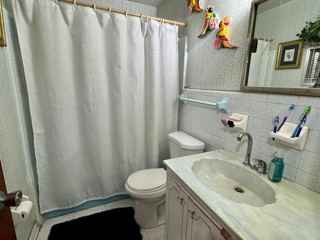 bathroom featuring tasteful backsplash, tile walls, toilet, vanity, and tile patterned flooring