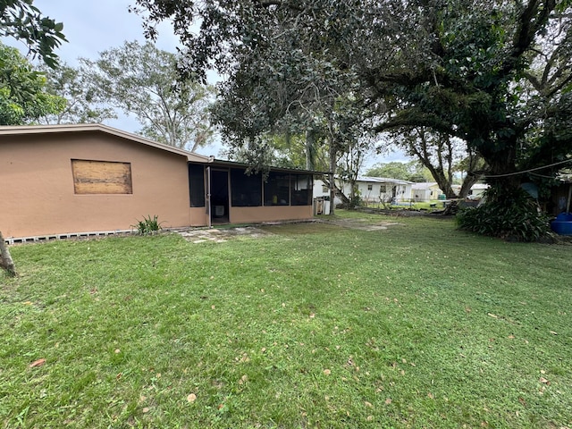 view of yard featuring a sunroom