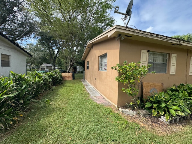 view of side of home featuring a lawn