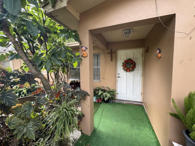 275 SE 16th Ave, Okeechobee, FL 34974 - doorway to property featuring stucco siding